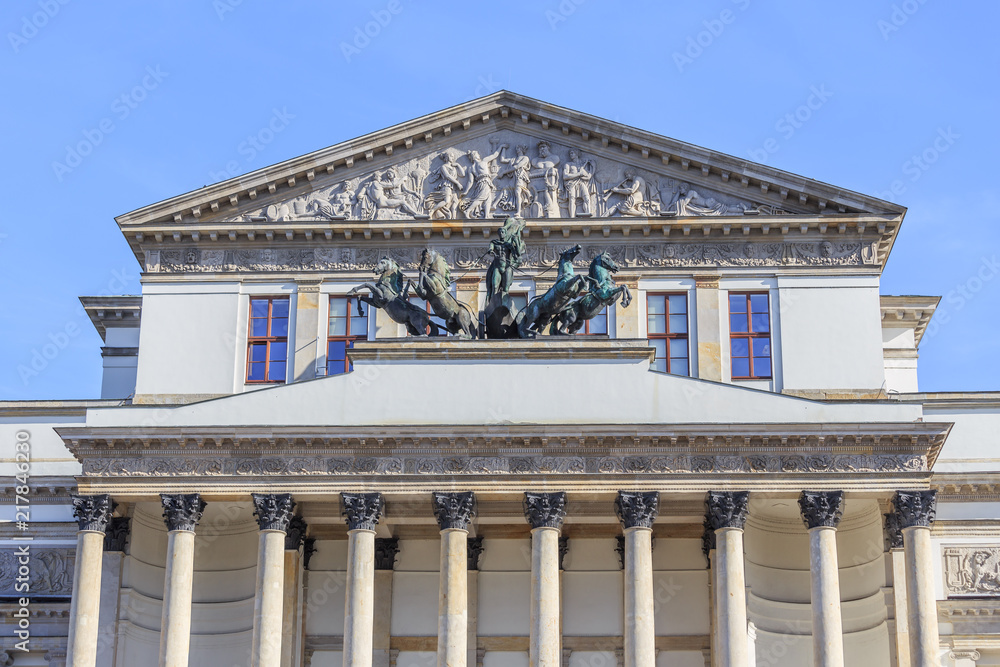 A fragment of historical west classicism facade over  main entrance to Warsaw Grand Theater.. IN Tympanum is sculpture Bust of Anakreont and three muse chisels by Tomasz Accardi. 