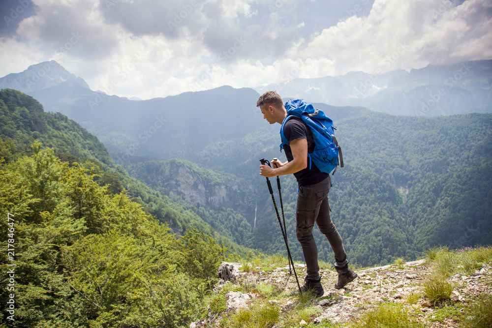 Free male hiker on mountain with breathtaking view