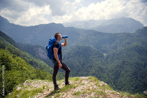 Thirsty mountaineer drinks water