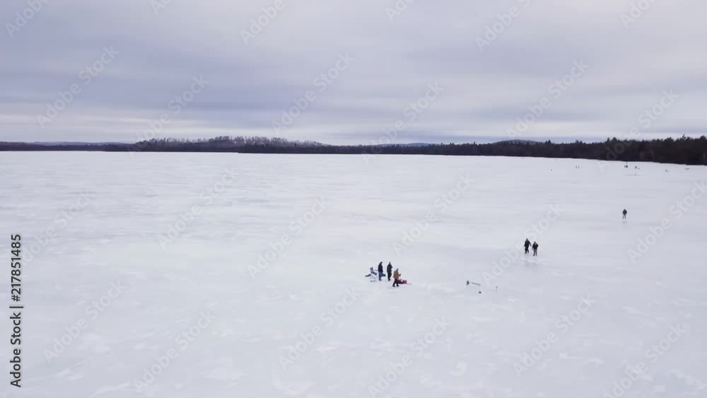 Get an aerial view of Ice Fishing on Fitzgerald Pond, Maine. Here we circle slowly around people walking around the ice. Get an aerial view of Ice Fishing on Fitzgerald Pond, Maine. Here we circle slowly around people walking around the ice.