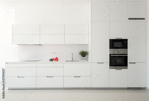 White empty classic kitchen in front view. Kitchen appliances.