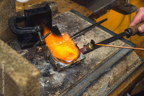Wallpaper Mural Goldsmith melting down metal with torch equipment to manufacture jewelry Torontodigital.ca
