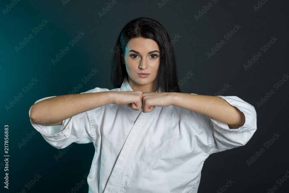 Sporty karate,taekwondo and kyokushin woman in white kimono with black ...