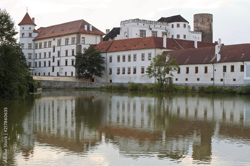 Czech republic, Jindrichuv Hradec - August 8, 2018: Castle in Jindrichuv Hradec during sunset in summer. Reflection of castle on surface of near pond. 