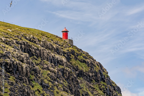 lighthouse on the outermost edge, on the faroe islands