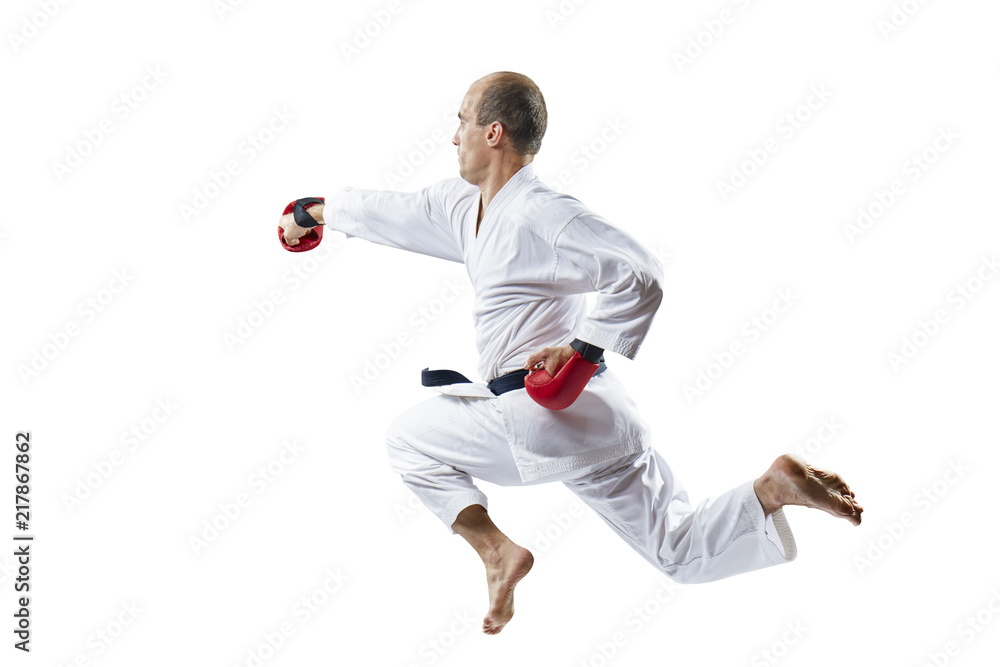 A man is training a punch the hand in jump on a white background A man is training a punch the hand in jump on a white background