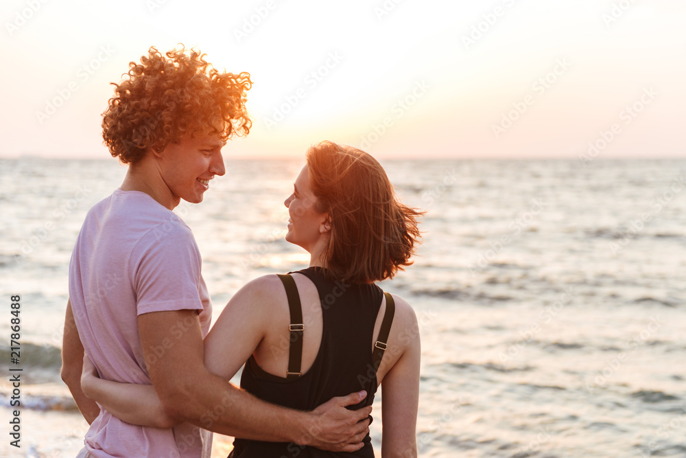 Portrait of a lovely young couple hugging at the beach Portrait of a lovely young couple hugging at the beach