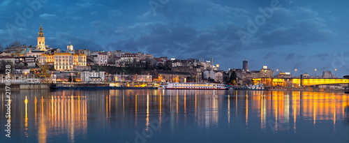 Old Belgrade panorama by night with Cathedral and Branko's bridge on Sava river and city lights water reflections