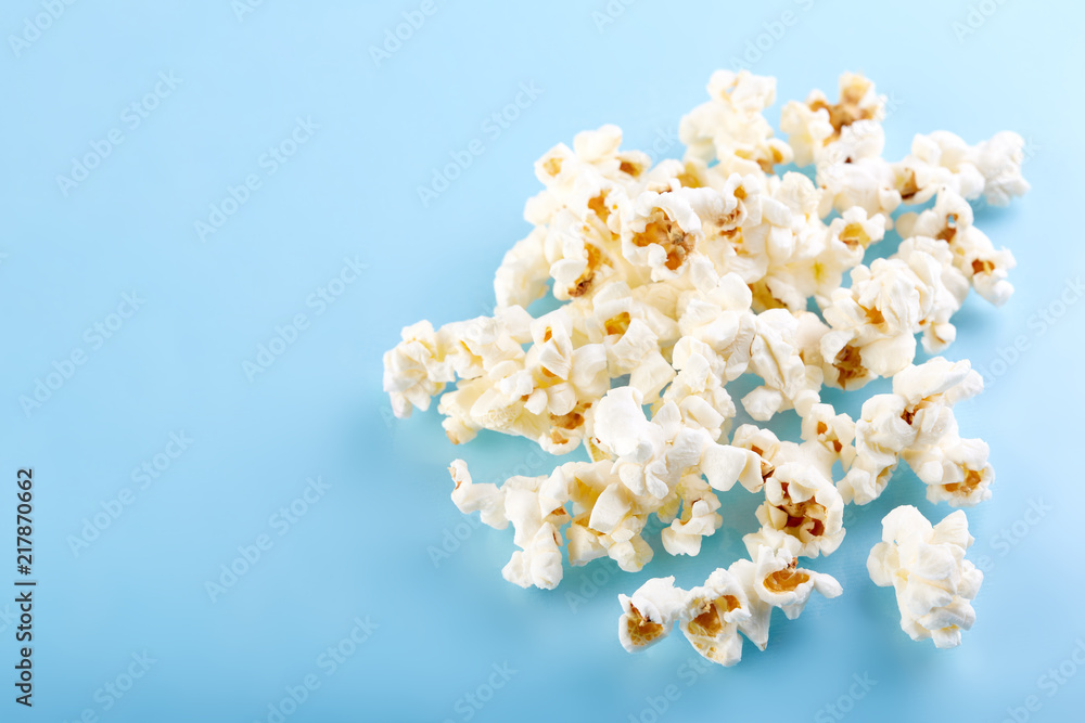 Popcorn on a bright blue background. Film. Fast food. Corn Popcorn on a bright blue background. Film. Fast food. Corn