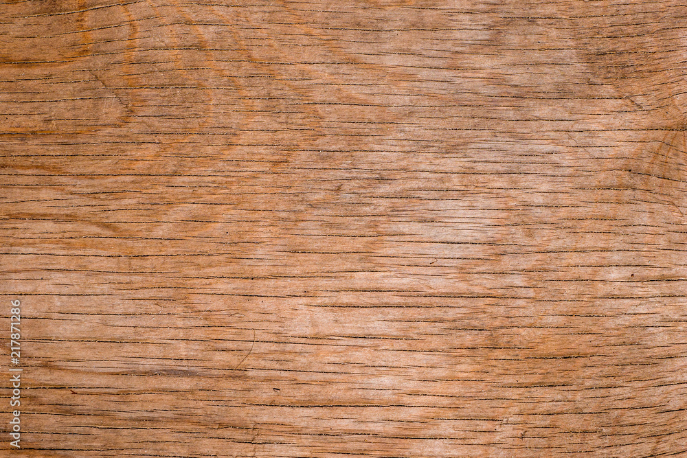 Horizontal lines on old cracked weathered surface of plywood as texture and background Horizontal lines on old cracked weathered surface of plywood as texture and background