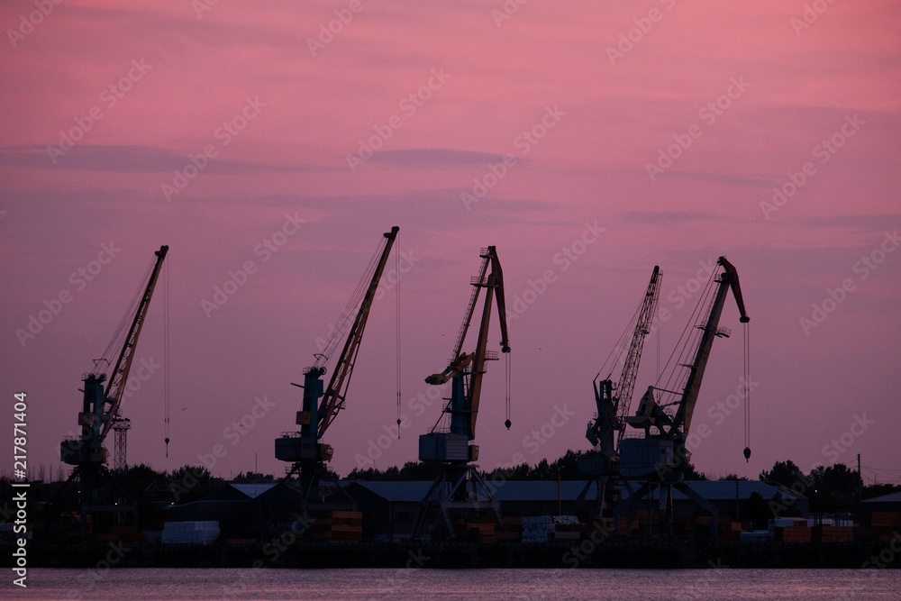 Wharf Cranes In Front Of Sunset Sky
