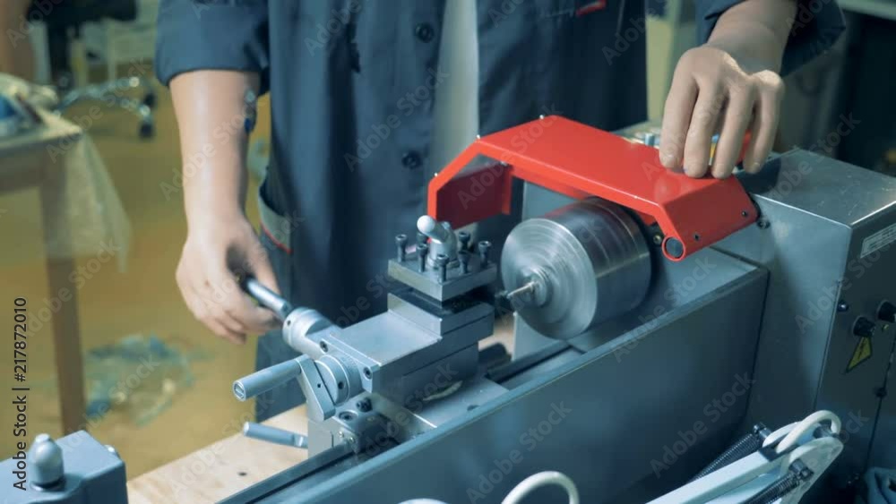 Man works at a factory, close up. Disabled person works at a plant with artificial hands. Man works at a factory, close up. Disabled person works at a plant with artificial hands.