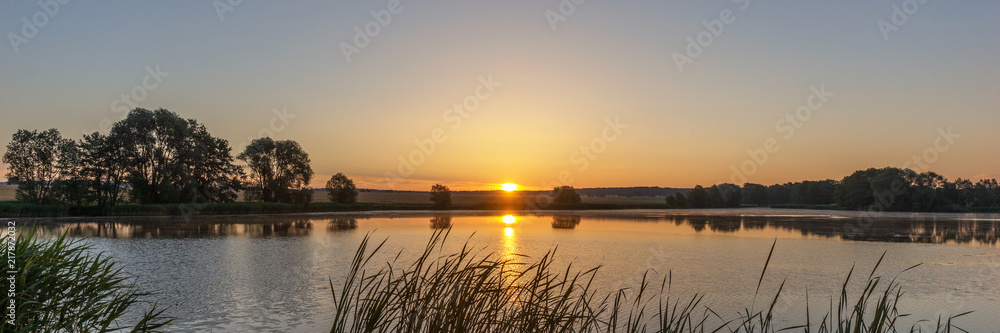 Beautiful sunrise in the summer by the lake. Saxony in Germany Beautiful sunrise in the summer by the lake. Saxony in Germany