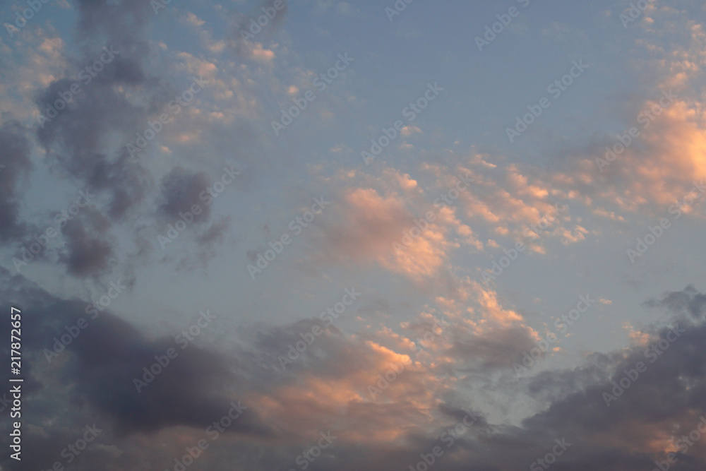 Pink sunset clouds on a light blue sky