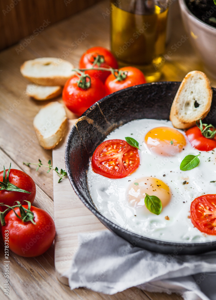 Scrambled eggs with tomatoes in a frying pan and croutons Scrambled eggs with tomatoes in a frying pan and croutons