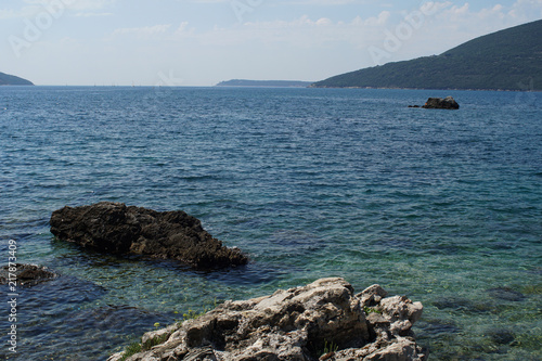 Rocky bay with giant boulders and wild herbs