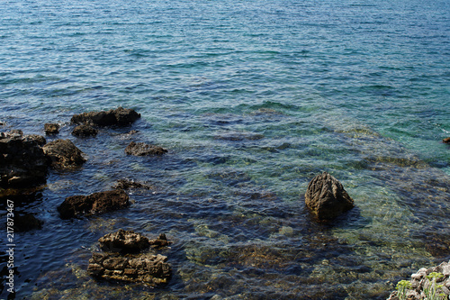 Rocky bay with giant boulders and wild herbs