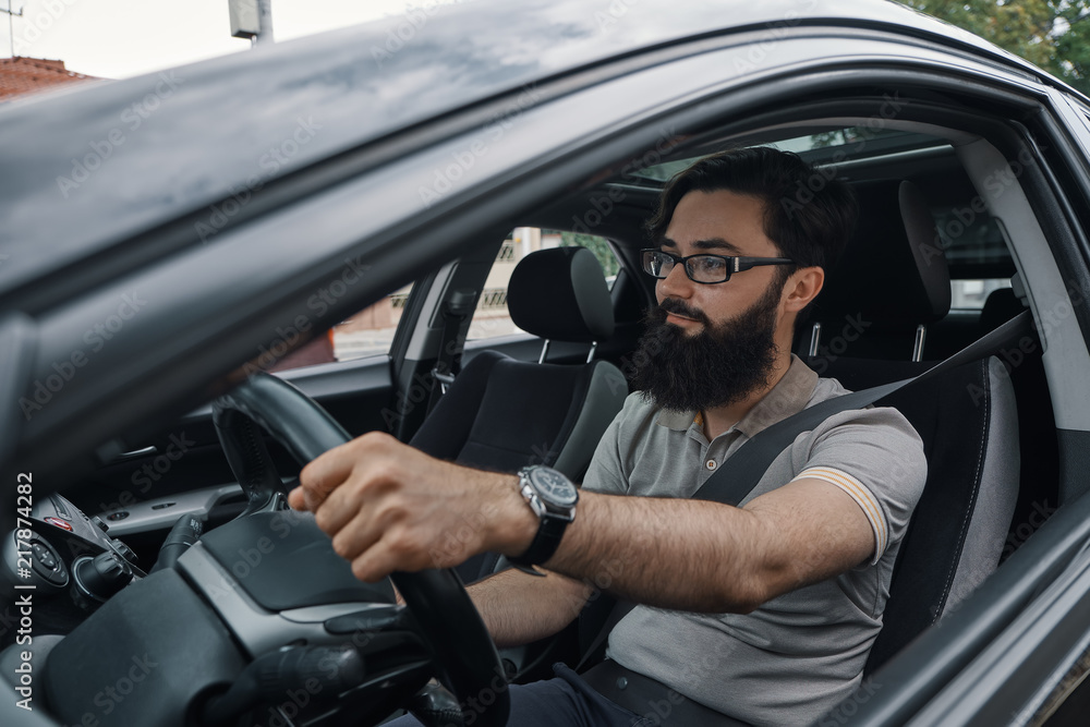 Modern casual bearded man driving a car Modern casual bearded man driving a car