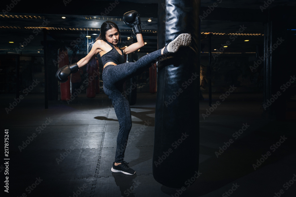 Female boxer hitting a huge punching bag at a boxing studio. Woman boxer  training hard. Thai boxer punch kick by punching bag, Black bacground  Photos | Adobe Stock