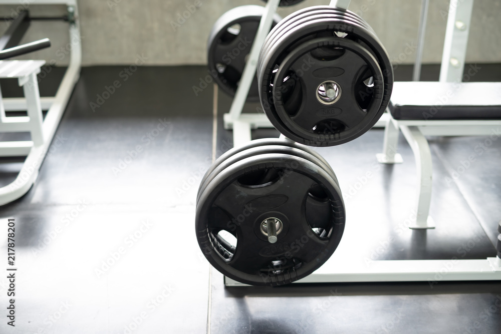 Fototapeta premium Black dumbbell set in gym. fitness and healthy lifestyle concept.