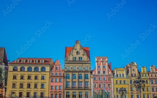 beautiful colorful buildings facade frame in old medieval city street district on blue sky background with empty space for copy or text