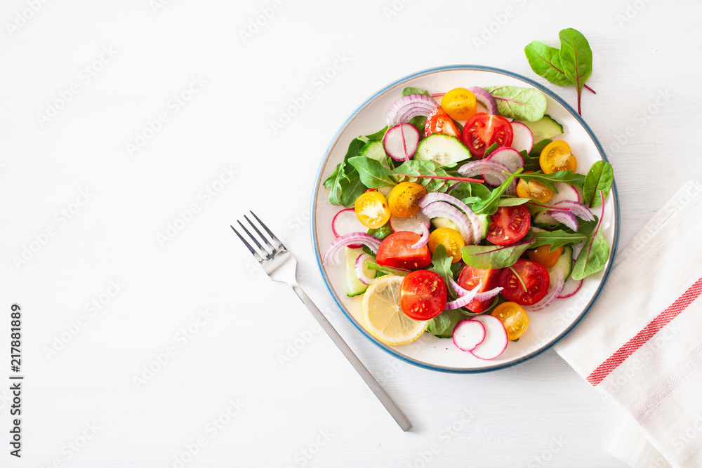 healthy colorful vegan tomato salad with cucumber, radish, onion healthy colorful vegan tomato salad with cucumber, radish, onion