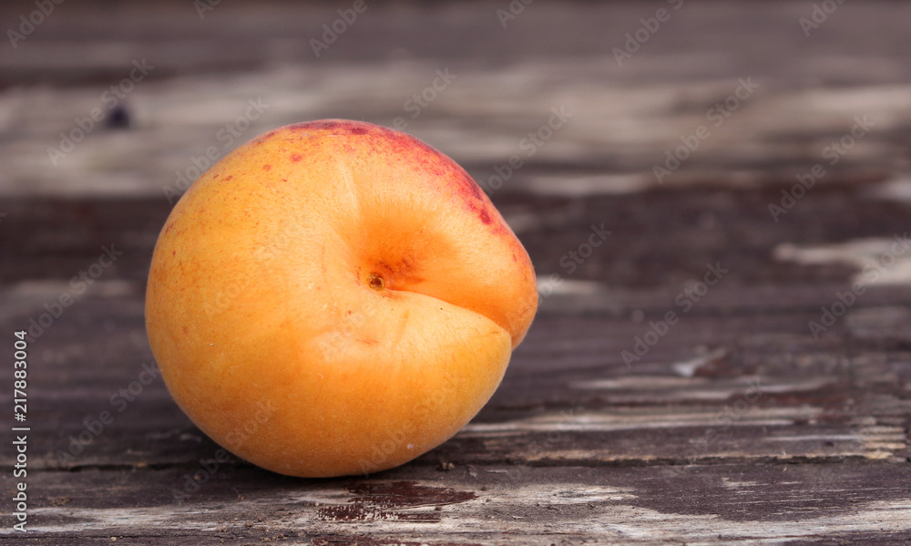 Ripe organic apricots on the wooden background. Space for text. Blurred background. Ripe organic apricots on the wooden background. Space for text. Blurred background.