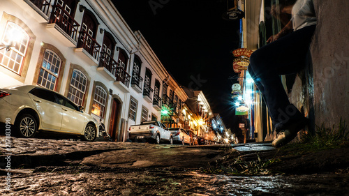 stone hill of storical city of ouro preto with cars parked photo