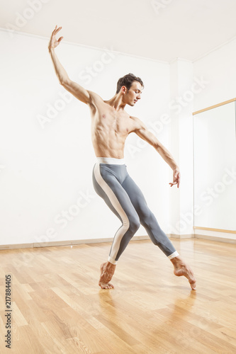 Young beautiful male ballett dancer posing in studio