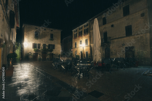 Old European illuminated street at rainy night