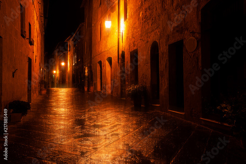 Old European illuminated street at rainy night