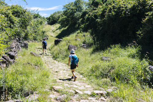 Two hikers on the ancient stone paved road from Barichara to Guane called 