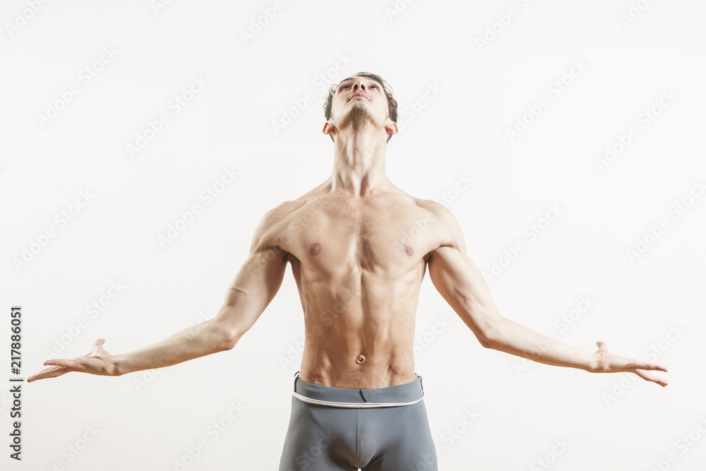 Fototapeta premium Young beautiful male ballett dancer posing in studio