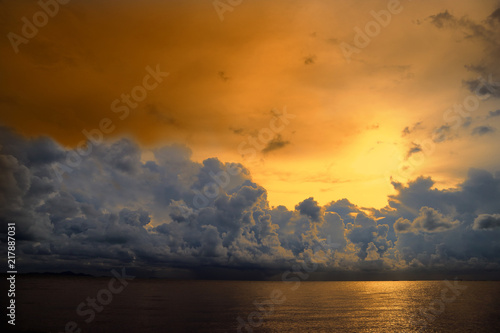 sunset sky over silhouette orange heap cloud on sea