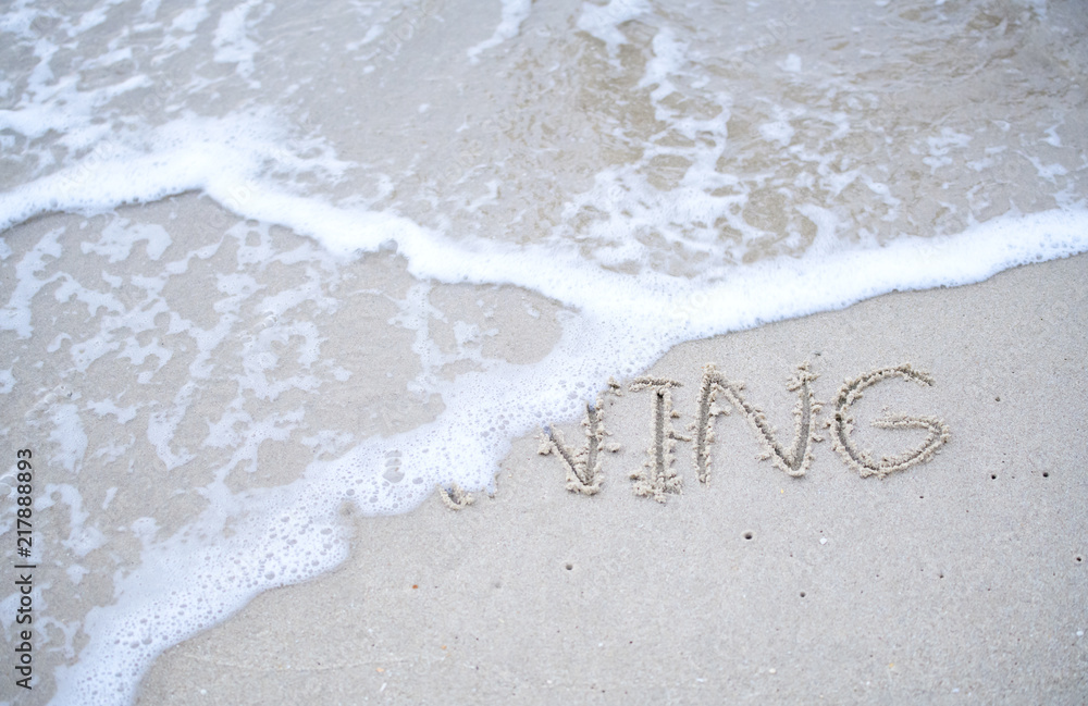 The text Hello morning written on the sand beach by the sea, used in greeting The text Hello morning written on the sand beach by the sea, used in greeting