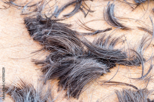 Short human hair cut off on the floor.