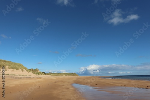 Blue sky with copy space over dunes, beach and sea
