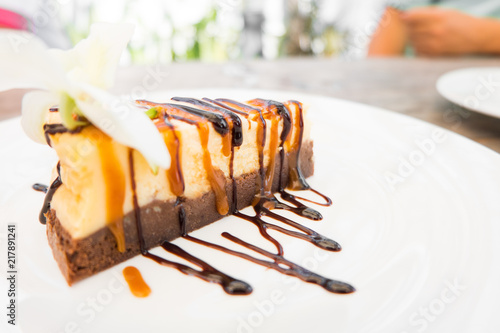Canvastavla Cheesecake slice with melted and crushed chocolate in white dish,sweet dessert