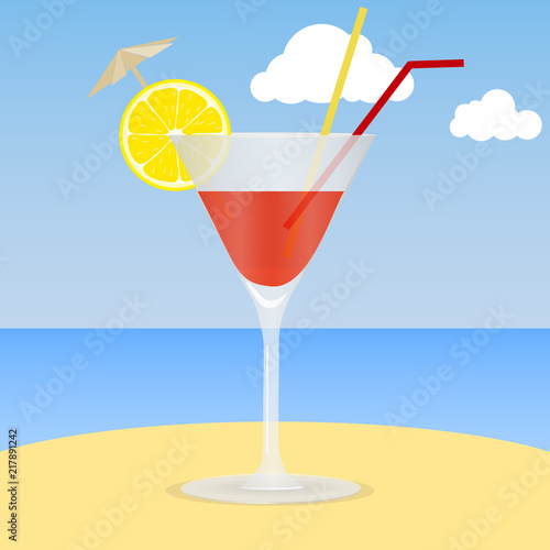 Cocktail on the beach. A glass of cocktail with an lemon slice on the sand against the background of the sea and sky. The concept of a beach holiday.
