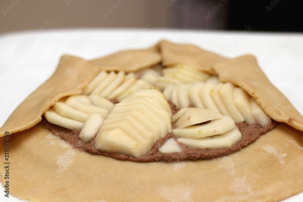 Making a pear and almond galette. Selective focus. Making a pear and almond galette. Selective focus.