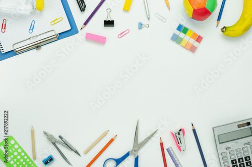 Table top view aerial image of back to school of education season background concept.Flat lay paper of variety stationary with note nook and essential objects on modern white wooden.space for mock up.