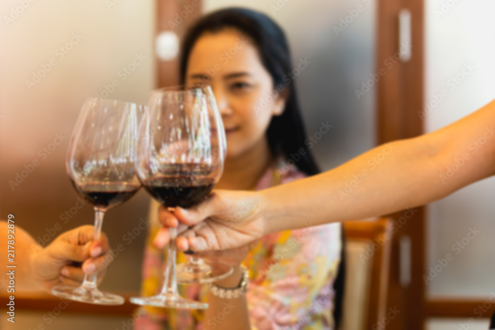 Group of friends raising a toast with glasses of red wine at family dinner. Group of friends raising a toast with glasses of red wine at family dinner.