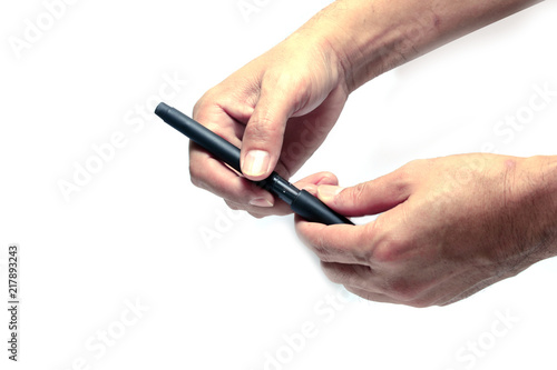 hand of a man holding a pen with removing a pen's cover action on white background isolated