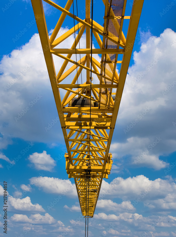 Yellow crane against the clear blue skies with lush clouds. Yellow crane against the clear blue skies with lush clouds.