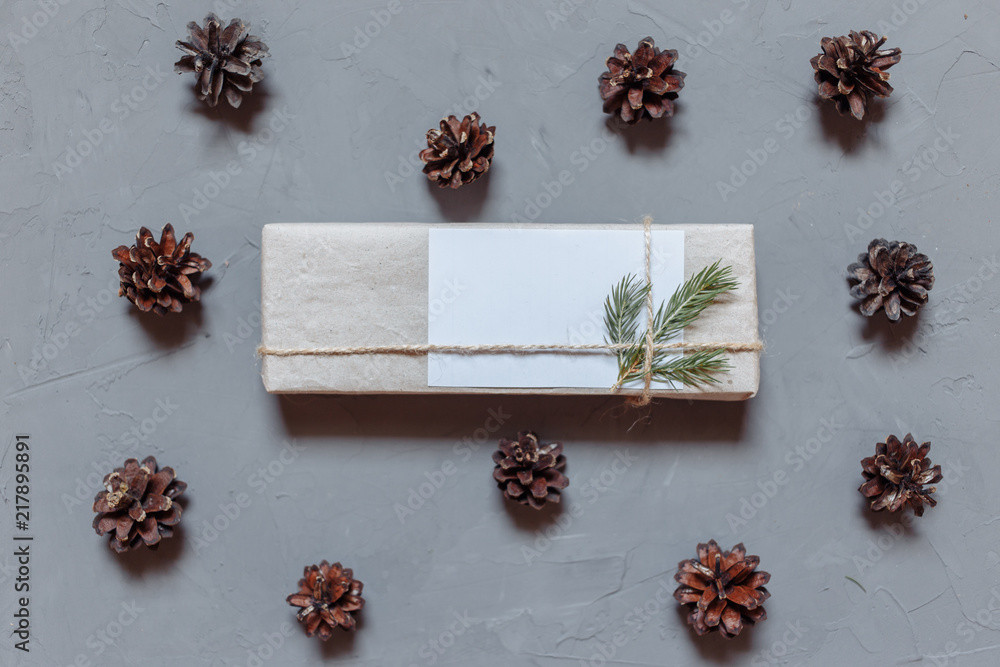 Christmas background with fir tree and decor, gift boxes. Top view with copy space, gray plastered background Christmas background with fir tree and decor, gift boxes. Top view with copy space, gray plastered background