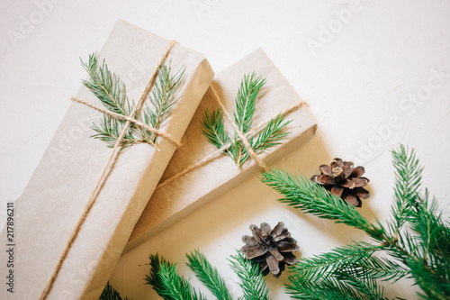 Christmas background with fir tree and decor, gift boxes. Top view with copy space, white background