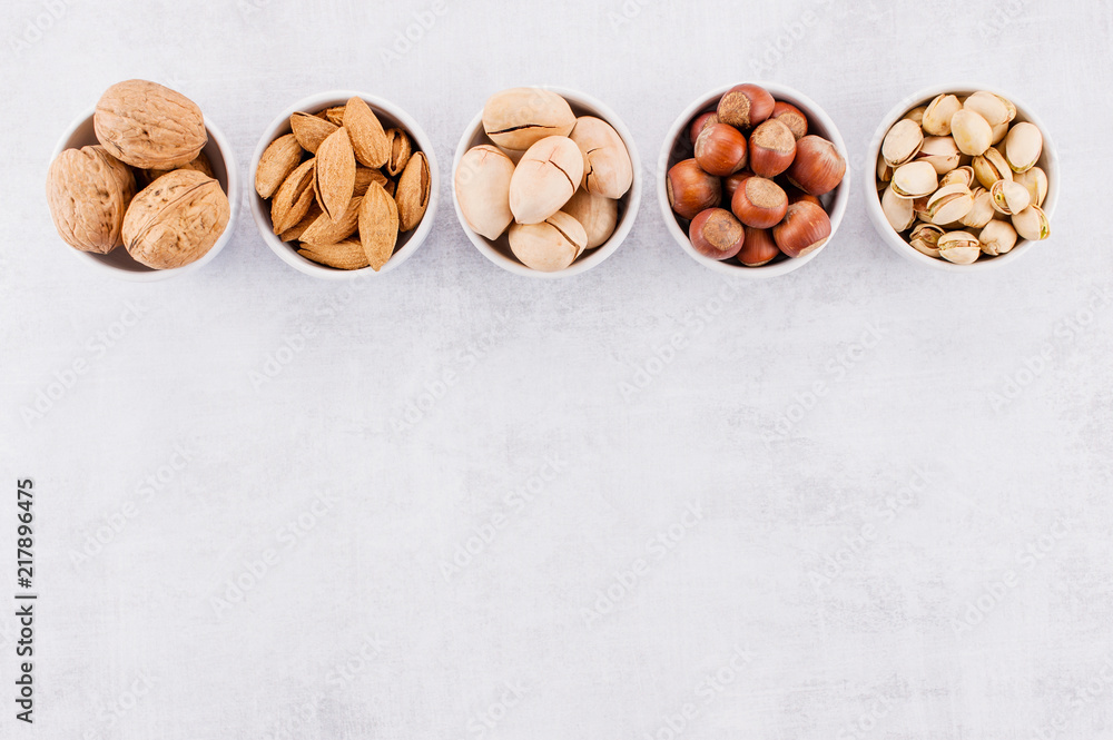 Background with various nuts in the small plates Background with various nuts in the small plates