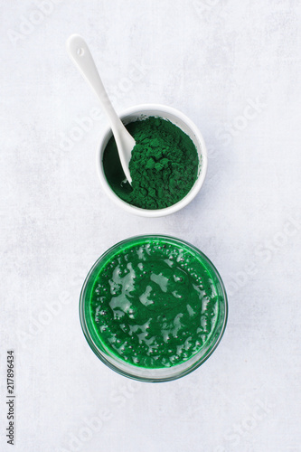 Spirulina powder and smoothie on the table