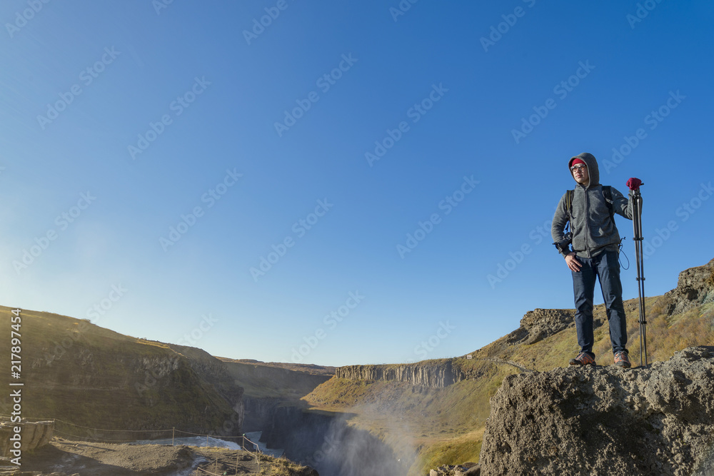 A traveler enjoy the view of Gullfoss waterfall , Iceland A traveler enjoy the view of Gullfoss waterfall , Iceland