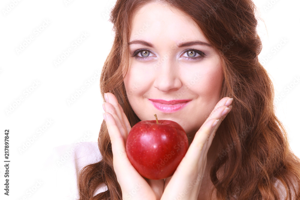 Woman holding apple fruit close to face Woman holding apple fruit close to face